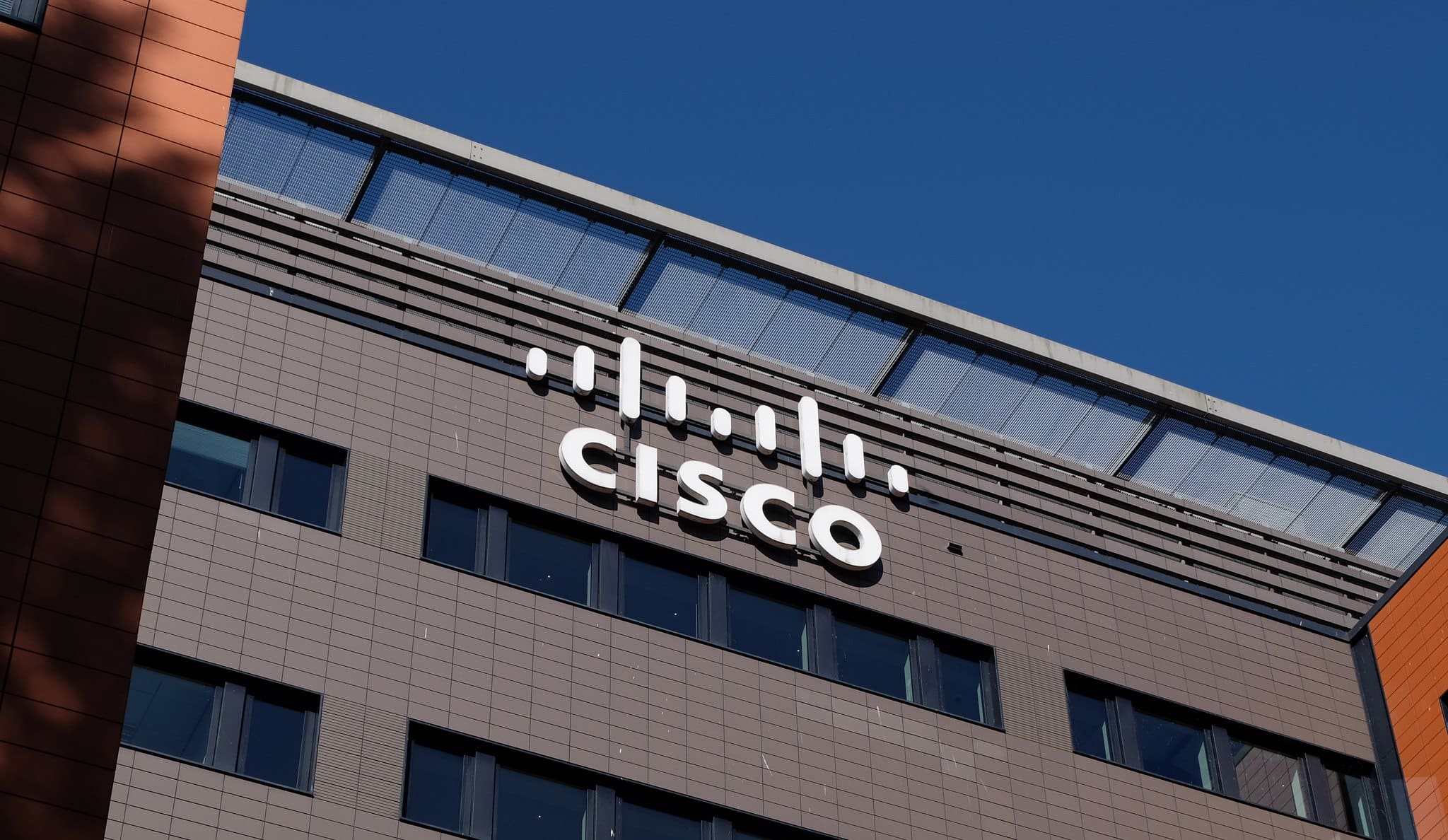 A close-up of the Cisco logo on a company building.