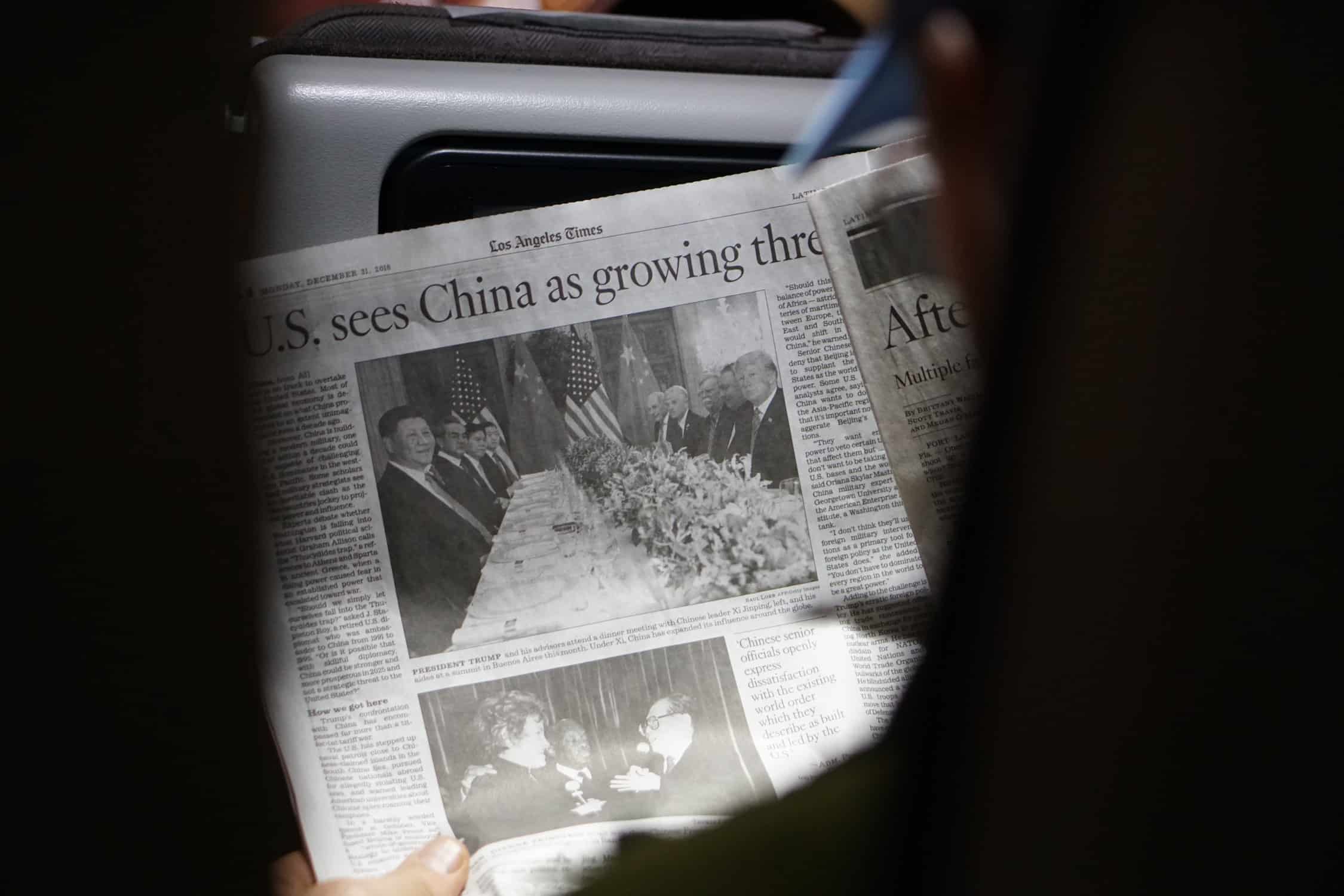 Person holding a newspaper.