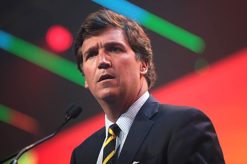 Medium shot of Tucker Carlson speaking.