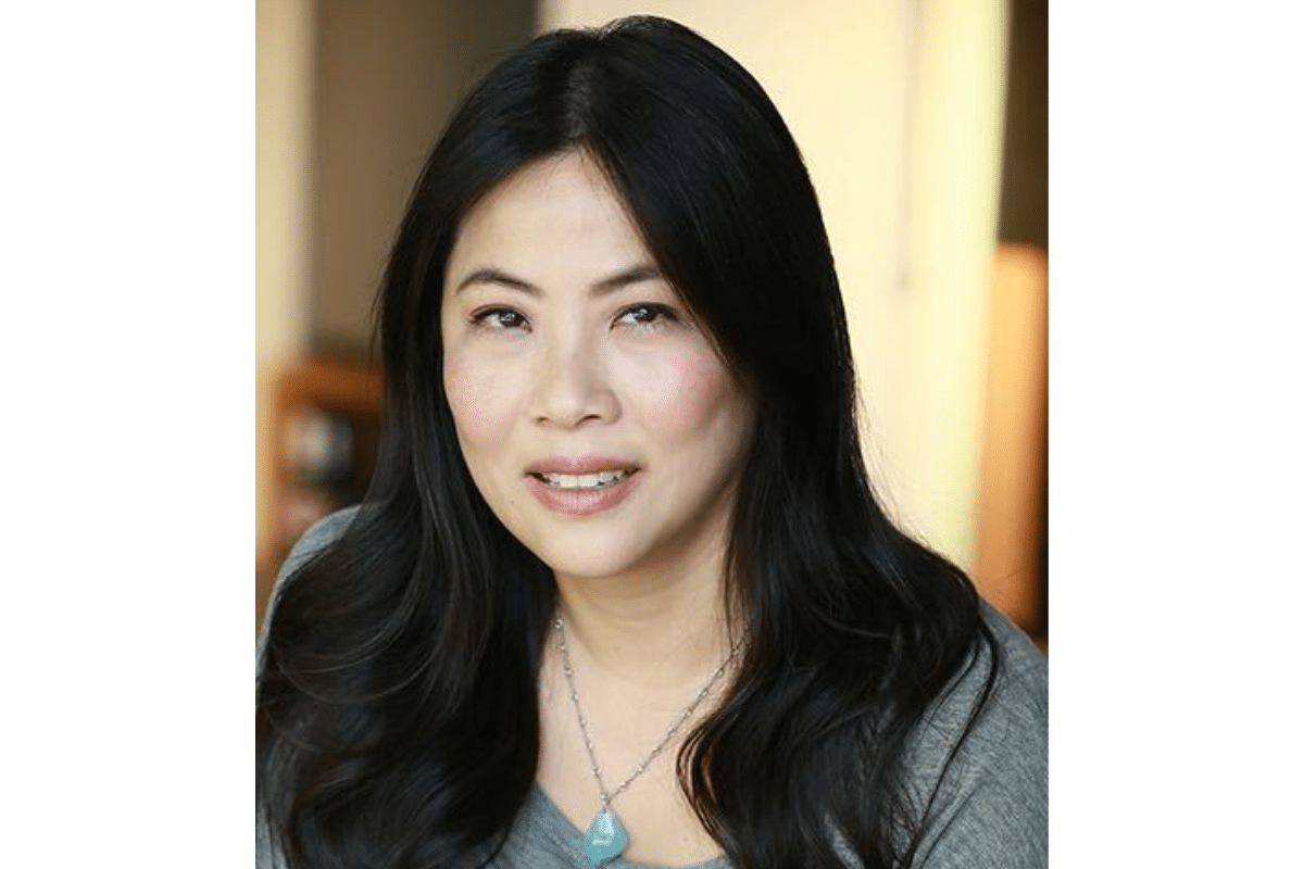 Headshot of Karen Yin. She wears a pendant necklace and a grey sweater.