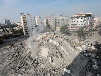 The rubble of the Watan Tower in Palestine being inspected by Palestinians.