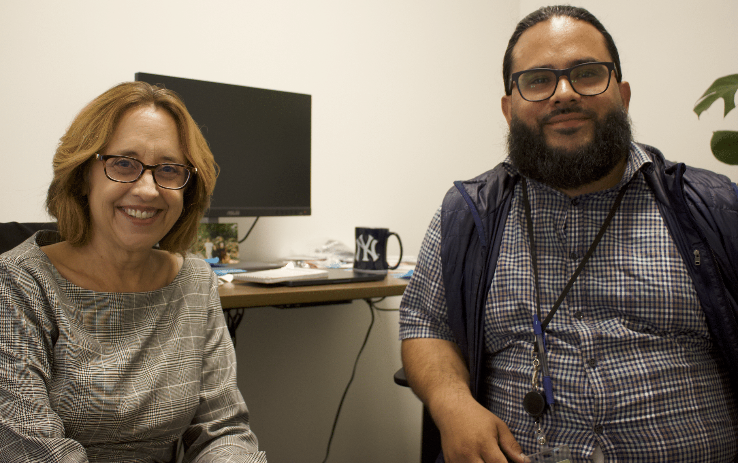 Richmondside Editor-in-Chief Kari Hulac and reporter Joel Umanzor sit side by side in the office.